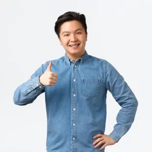 smiling-pleased-asian-male-student-with-braces-showing-thumbs-up-recommend-product-service-with-excellent-quality-like-approve-idea-man-nod-approval-agree-with-person-white-background